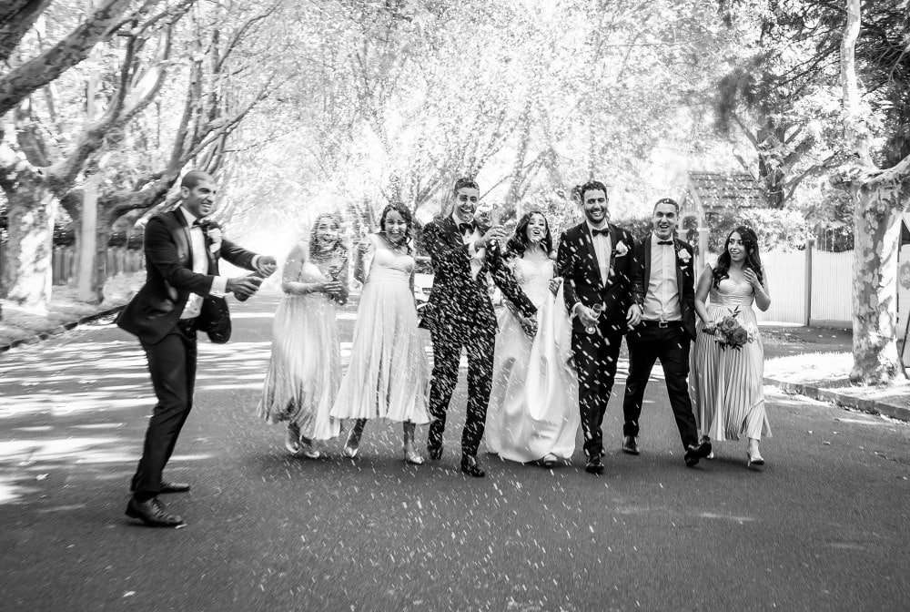 wedding photography package Melbourne bestman is popping poppers for the bride and groom