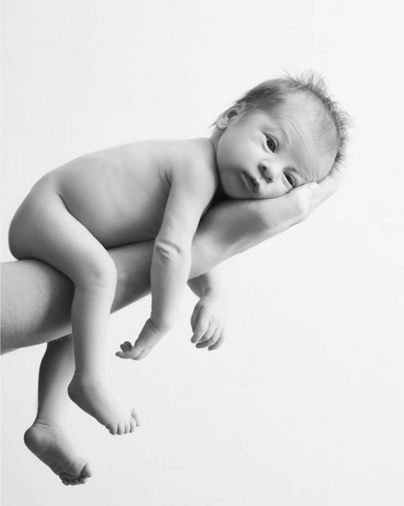 Sydney newborn photography baby is sleeping on fathers arm