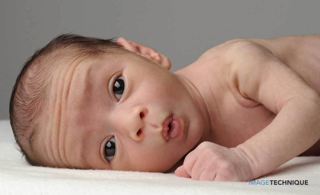 newborn photography Sydney baby's expression looks like in astonishment