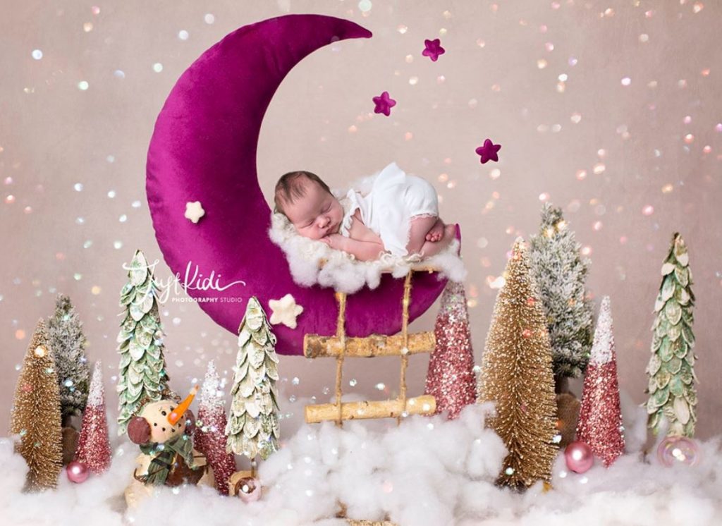 baby photoshot Sydney newborn is sleeping on a purple crescent moon