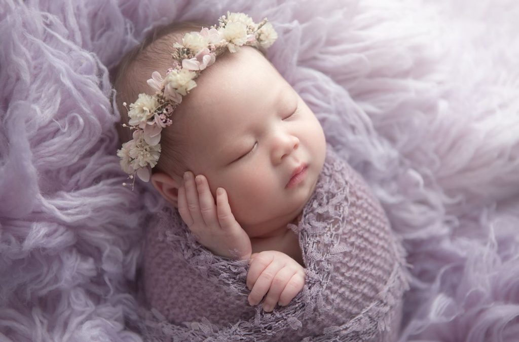 newborn photographer Sydney baby is sleeping with flower crown and covered with lavender blanket