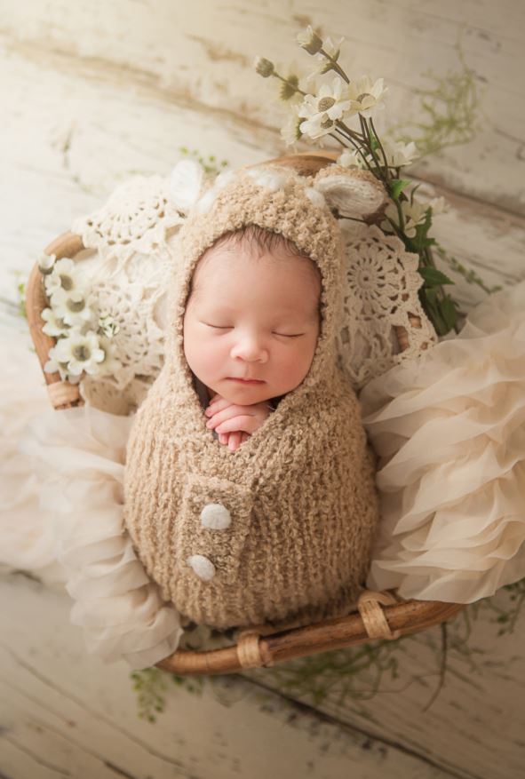 baby photoshot Sydney newborn is sleeping with a beige blanket