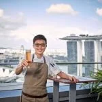 portrait photographer singapore a man holding a beer and posing for the photo