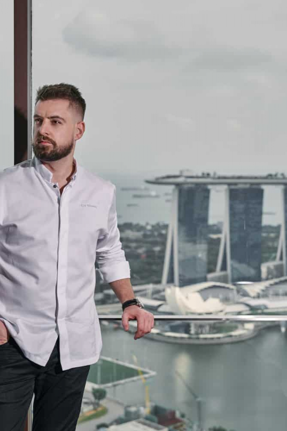corporate photoshoot singapore a man in white shirt with the view of Marina Bay Sands