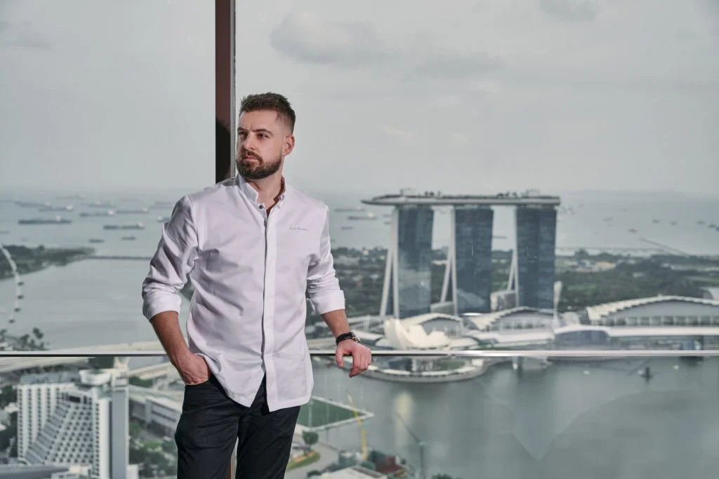 corporate photoshoot singapore a man in white shirt with the view of Marina Bay Sands