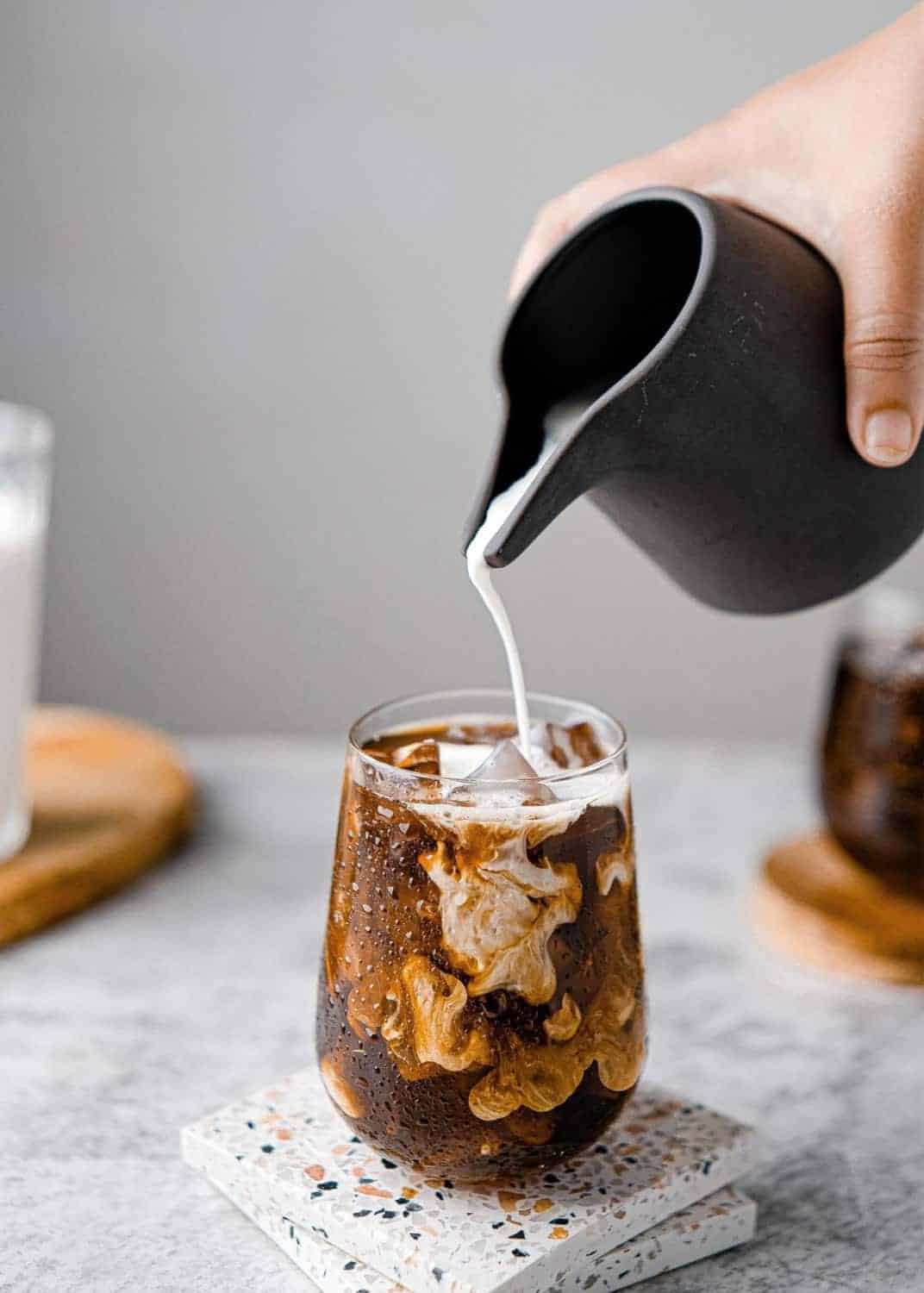 food stylist singapore milk poured into a cup of coffee