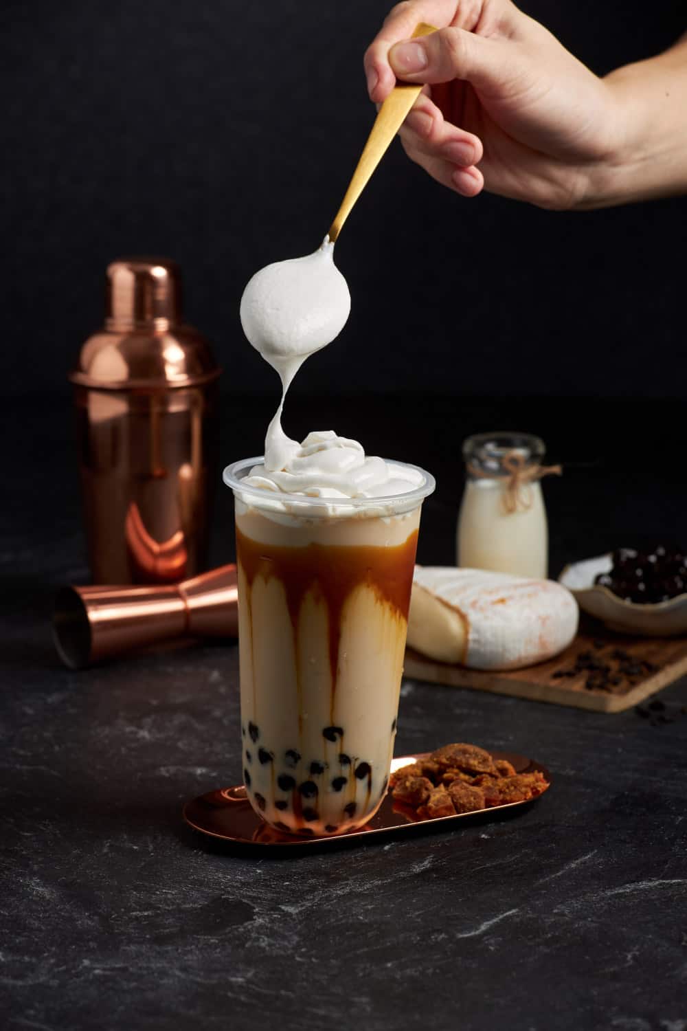 food photographer Singapore a milk tea with pearls topped with whipped cream