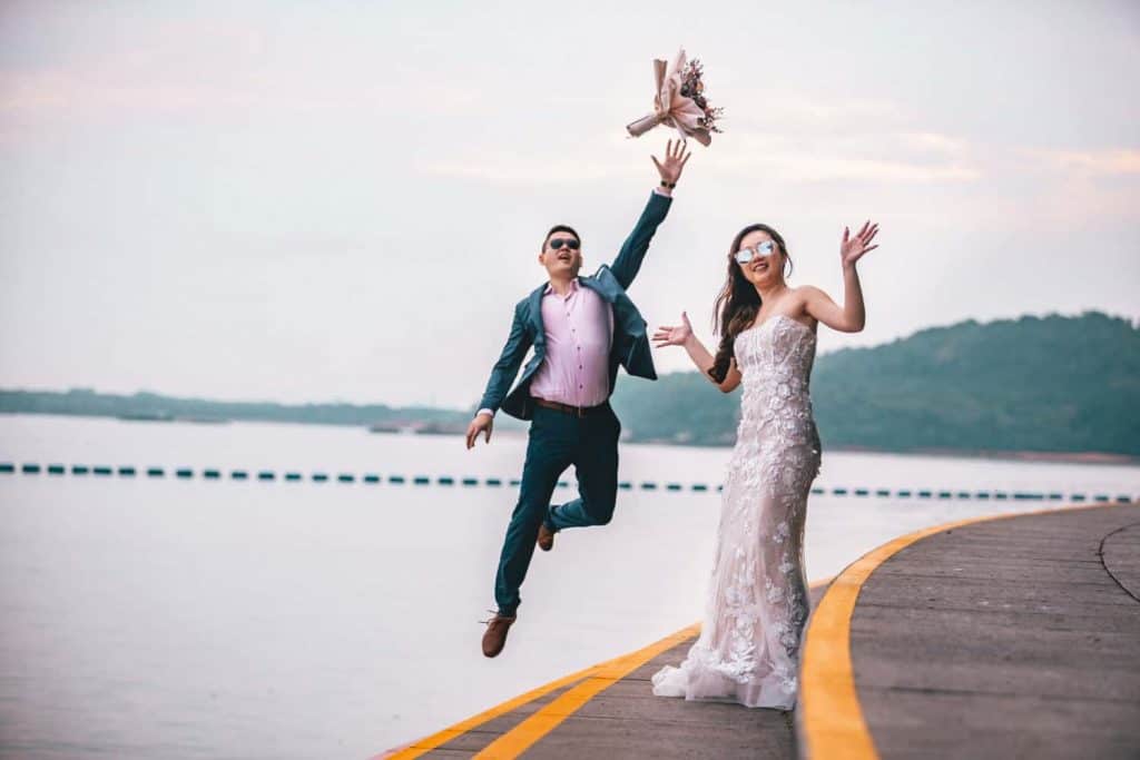 wedding photography package the couple is happily posing for the photo and the guy has thrown the bouquet in the air