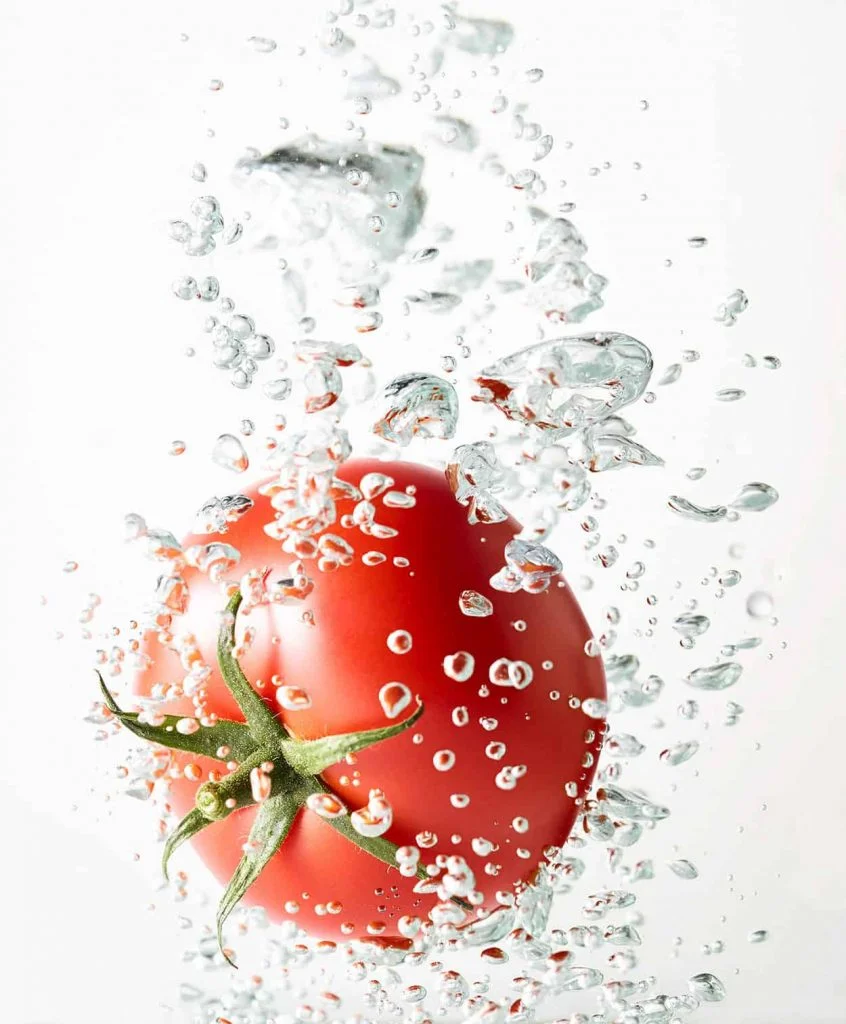 food photographers in london a fresh tomato in water