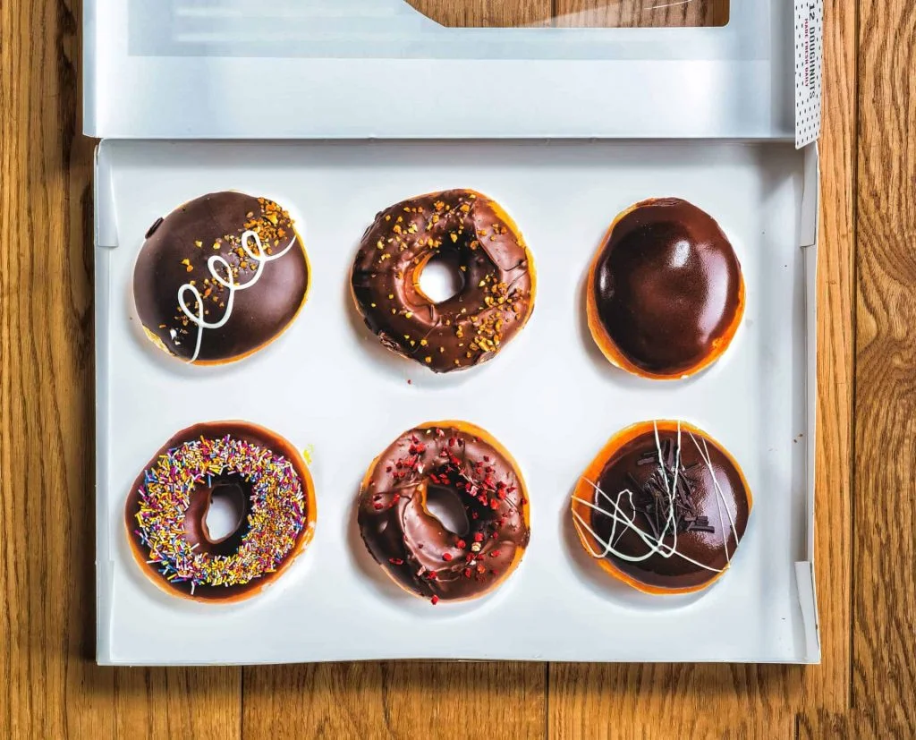 food photography dessert a box of six chocolate doughnuts