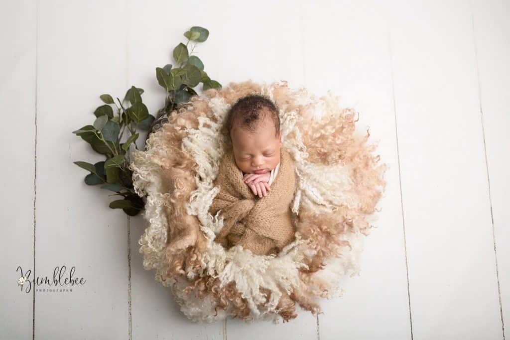 London newborn photography a baby on a neutral tone laced basket