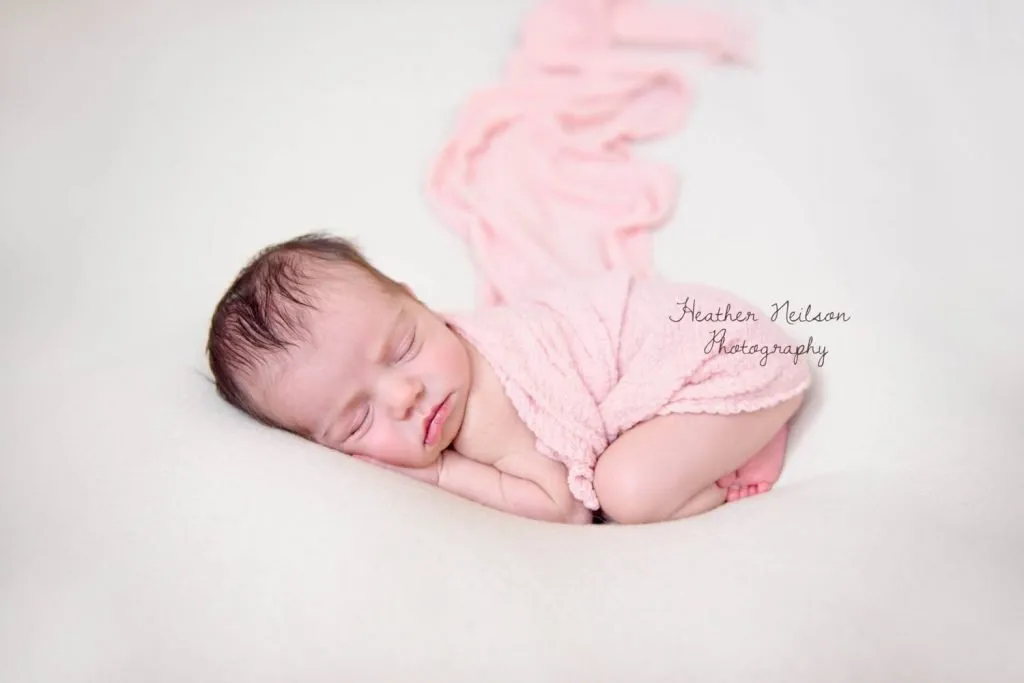 baby photographers Londonnewborn is sleeping with a baby pink blanket