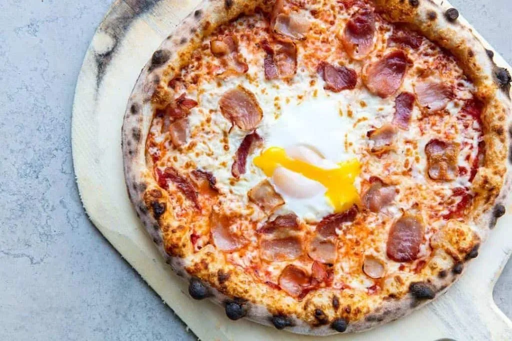 A food photographers' delight with bacon and an egg on a pizza in Toronto.